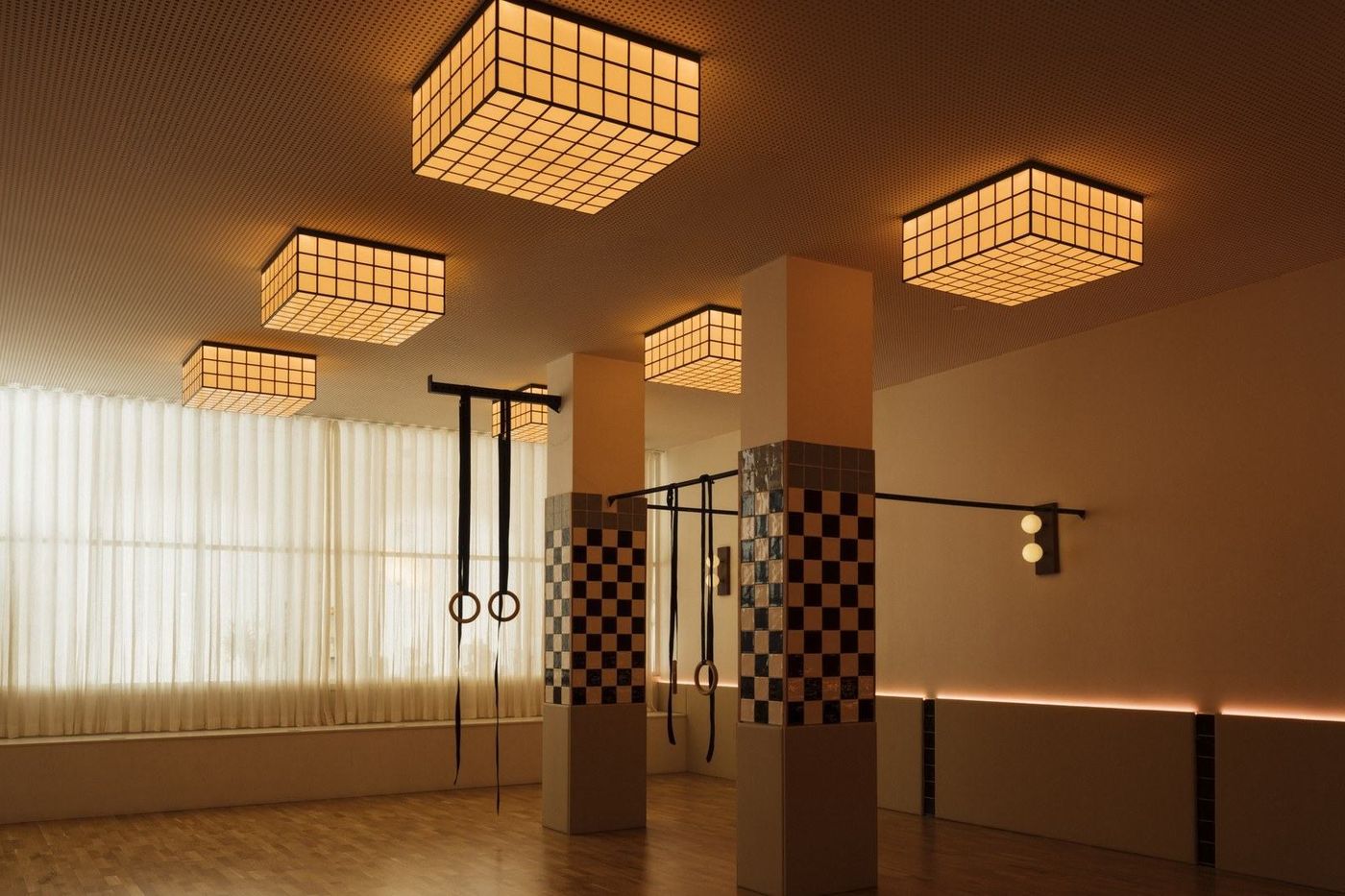The movement room at MVMT Studio, empty, with its sprung wooden floor and ambient lighting